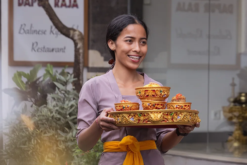 Balinese girl serving food